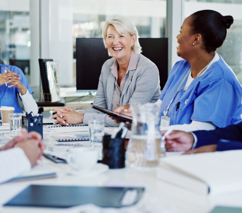 Boardroom, collaboration and healthcare with hospital manager speaking to staff for medical planning. Administration, corporate and management with professional talking to medicine team in clinic